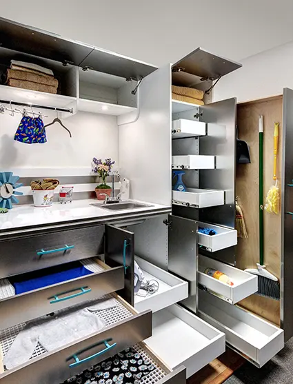 Laundry room items stored in organized slide out drawers