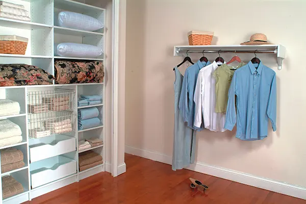 Linen closet neatly organized with custom shelves