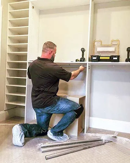 Handyman installing a custom closet system