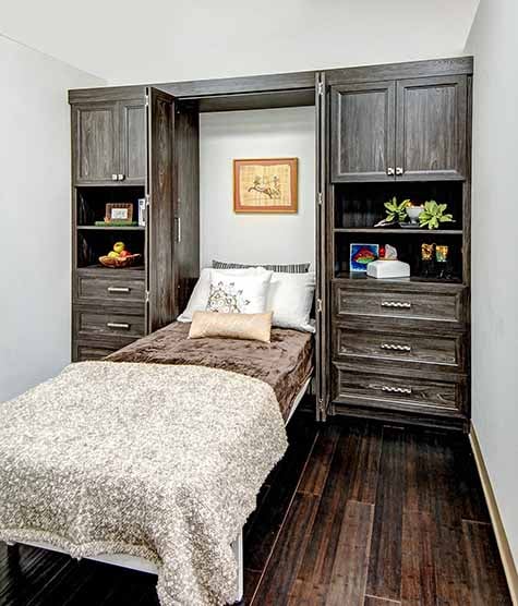 Bifold Murphy bed open with surrounding cabinetry