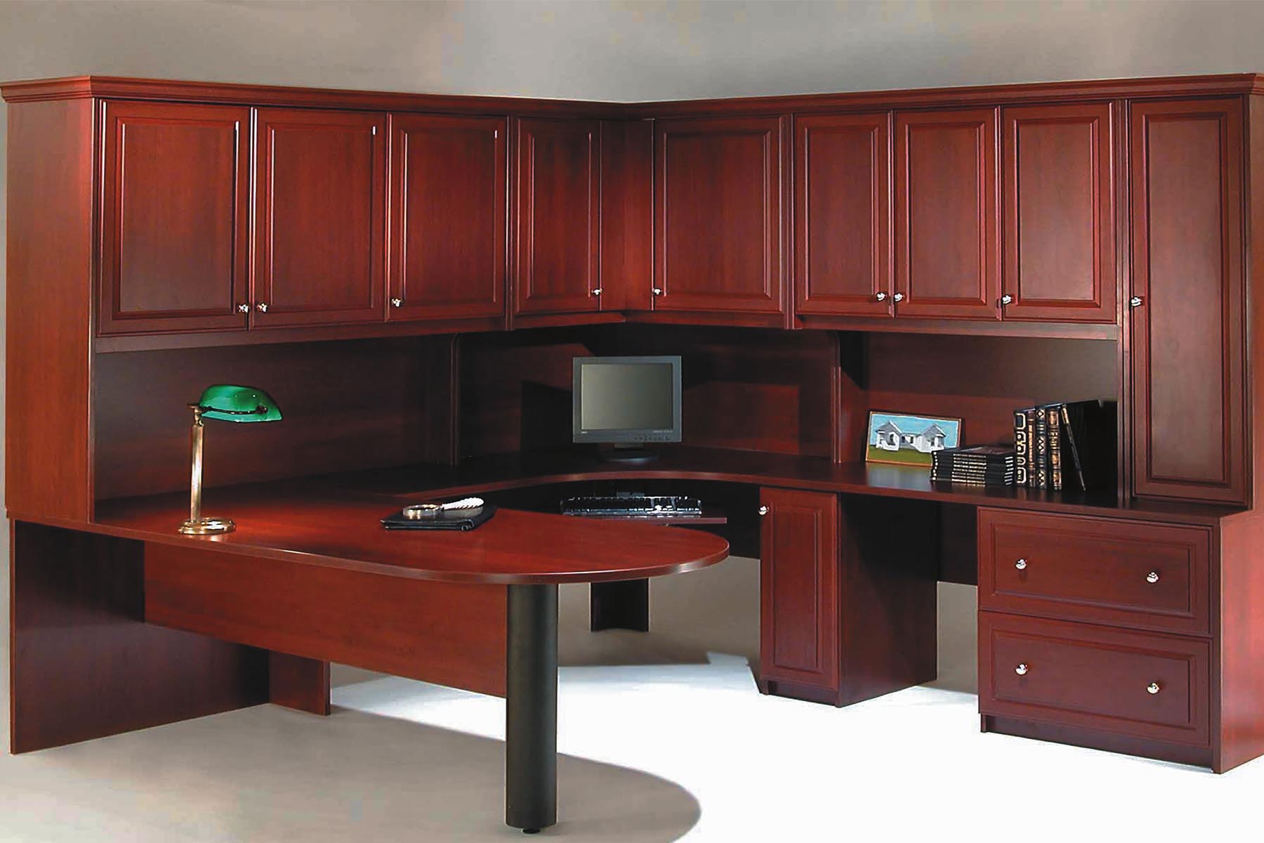 Custom home office finished with cherry cabinets and wrap around desk