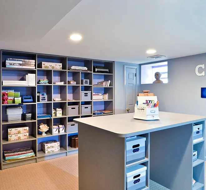 Craft and hobby room with art supplies organized on shelves