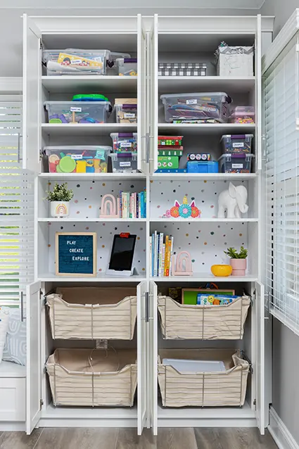 Kids school supplies neatly organized on shelves and slide out bins