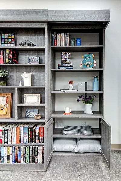 Sliding bookcase with storage to built in unit