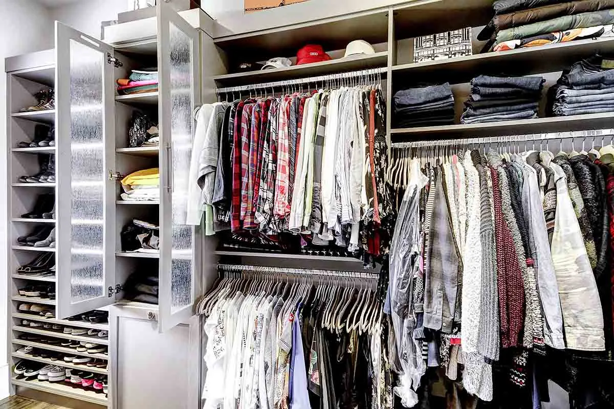 Walk-in closet design in Radnor, PA with light wood and multi-hanging sections