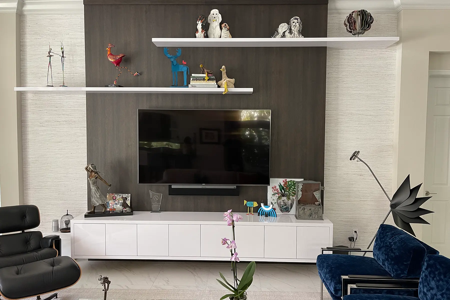 Media center finished in white wood with floating shelves