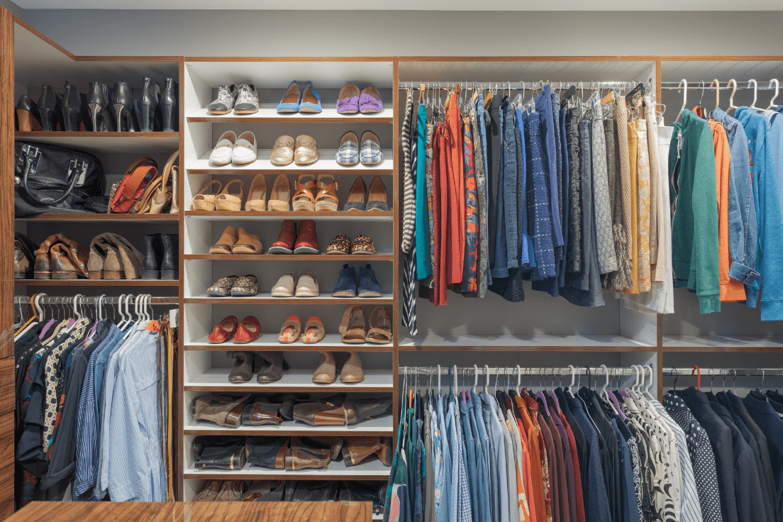Custom closet with adjustable shoe shelving, double-hang rods, and organized storage for clothing, shoes, and accessories.