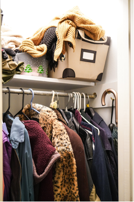 Basic reach-in closet with a single hanging rod, overhead shelf, and limited storage space.