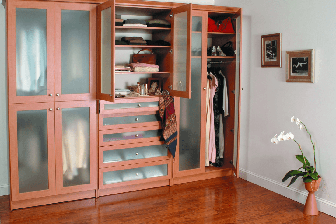 Built-in wardrobe with closed cabinetry, drawers, shelving, and hanging storage.