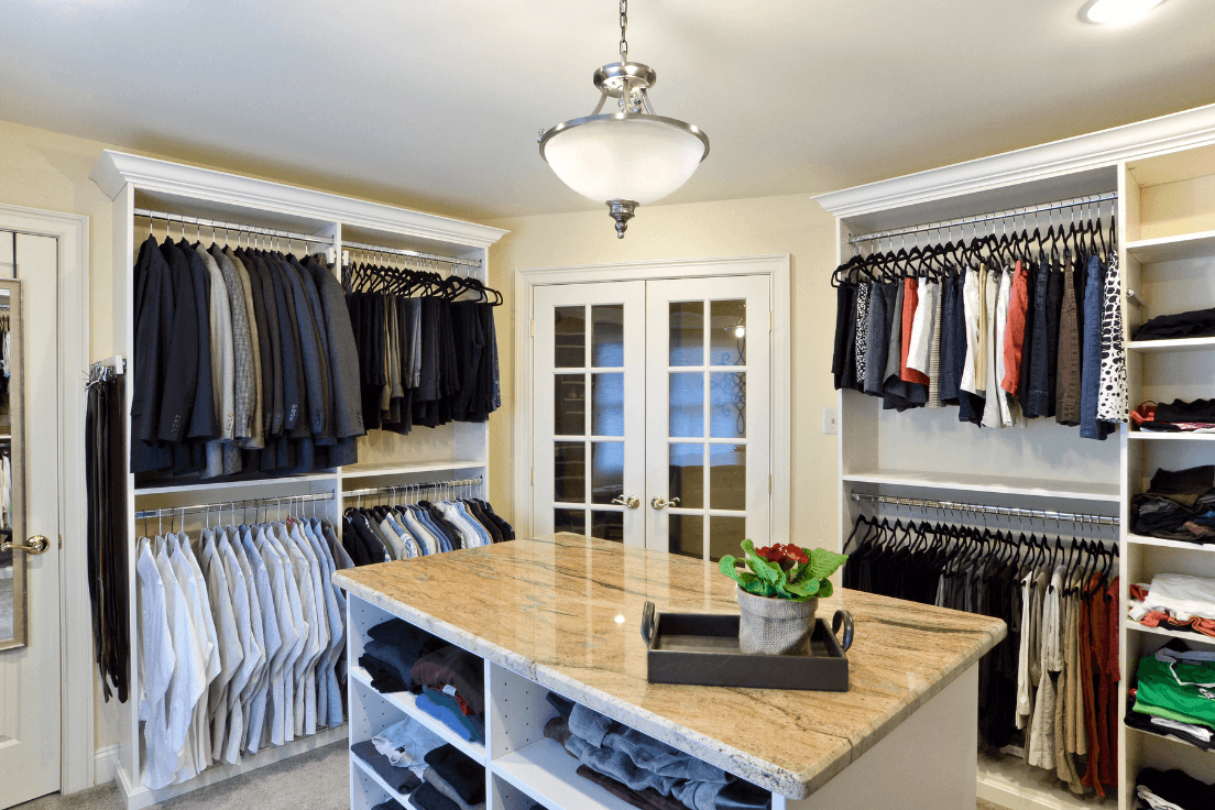 Shared walk-in closet with separate hanging and storage areas on opposite sides of a center island.