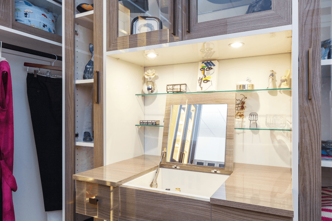 Custom closet vanity with a flip-up mirror and concealed storage.